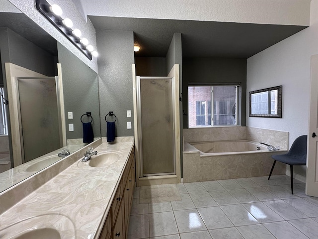full bath with a sink, a garden tub, a shower stall, and double vanity