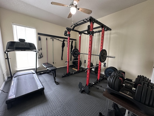 exercise area featuring baseboards and ceiling fan