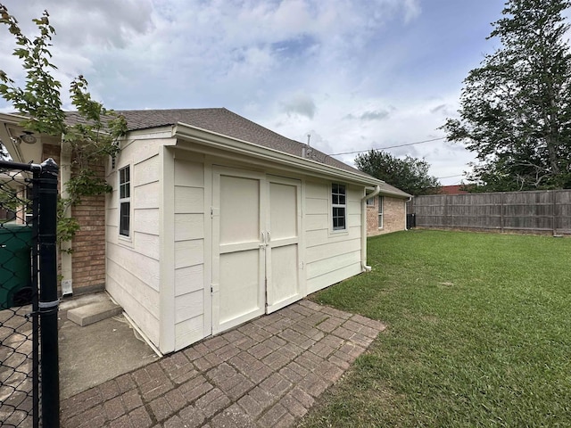 view of outbuilding with fence and an outdoor structure