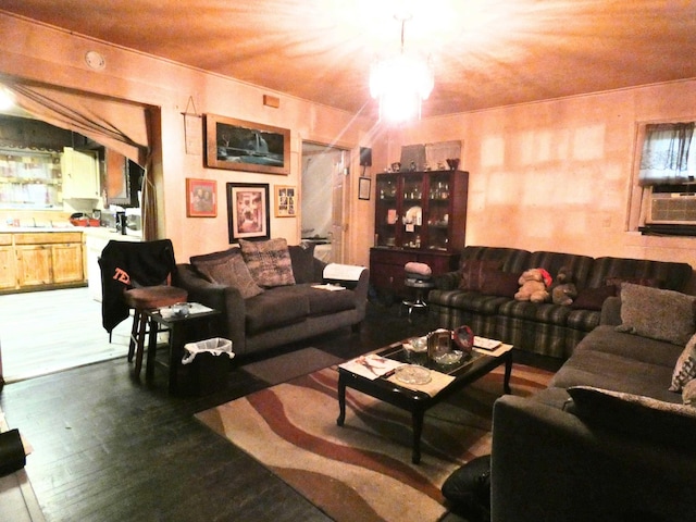 living room featuring dark hardwood / wood-style floors and a notable chandelier