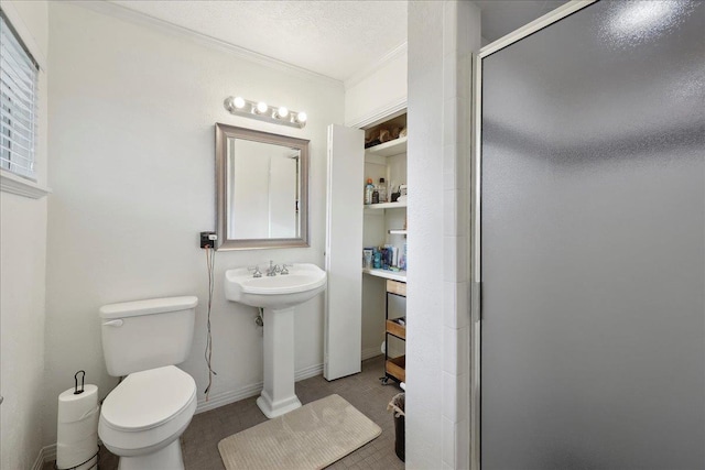 980 N 23rd St, Beaumont, TX 77706 - bathroom featuring crown molding, a stall shower, toilet, and baseboards