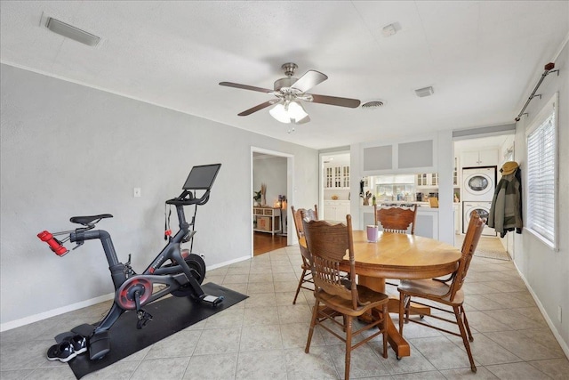 980 N 23rd St, Beaumont, TX 77706 - dining space with estacked washer and dryer, ceiling fan, and baseboards