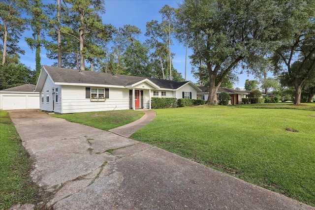 980 N 23rd St, Beaumont, TX 77706 - ranch-style house with a front lawn, an outbuilding, and a garage