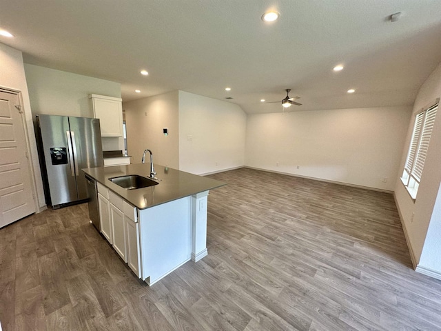 1525 Holly Trl, Sour Lake, TX 77659 - kitchen featuring stainless steel appliances, dark countertops, ceiling fan, wood finished floors, and white cabinets