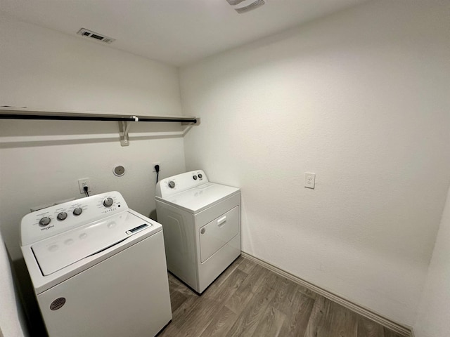 1525 Holly Trl, Sour Lake, TX 77659 - washroom with washer and clothes dryer and light wood-style floors