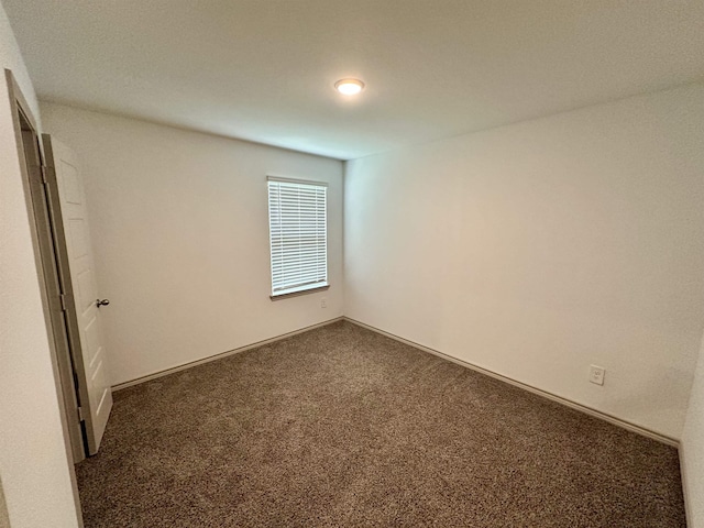 1525 Holly Trl, Sour Lake, TX 77659 - unfurnished room featuring carpet flooring and baseboards