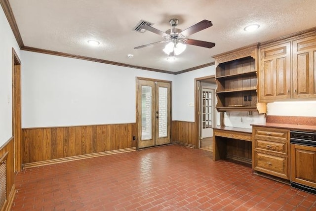 kitchen with built in desk, ornamental molding, french doors, and ceiling fan