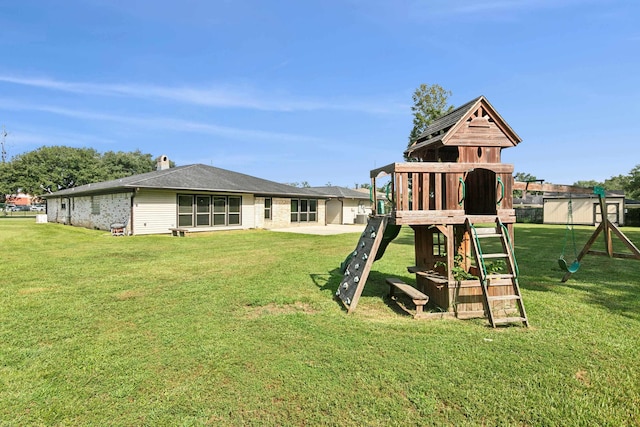 view of playground with a lawn