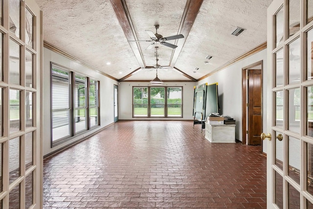 unfurnished living room featuring crown molding, vaulted ceiling, ceiling fan, and french doors