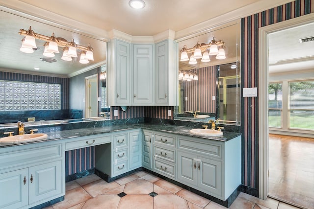 bathroom with crown molding, vanity, a shower with shower door, and tile patterned flooring