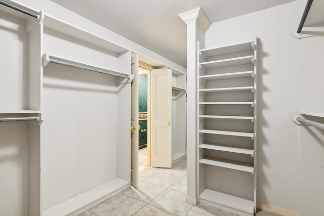 spacious closet featuring light tile patterned flooring