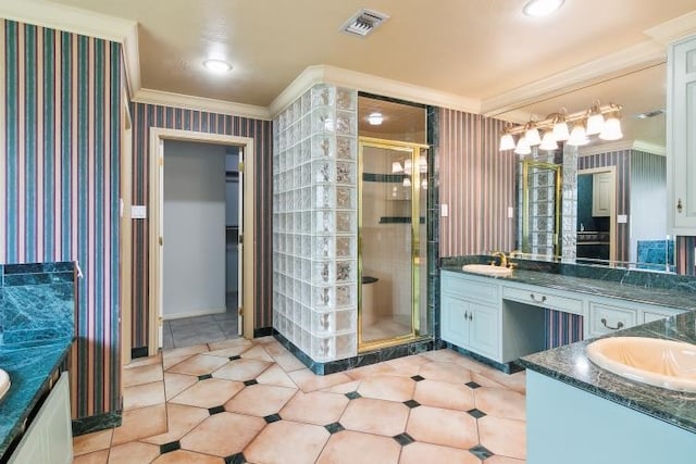 bathroom with ornamental molding, a shower with shower door, and vanity