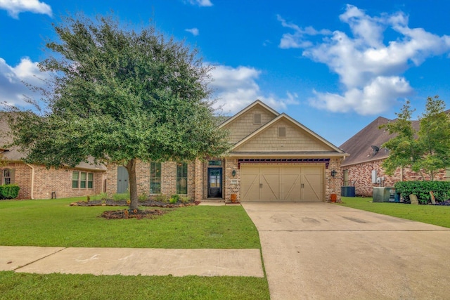 view of front facade with a front yard, central AC, and a garage