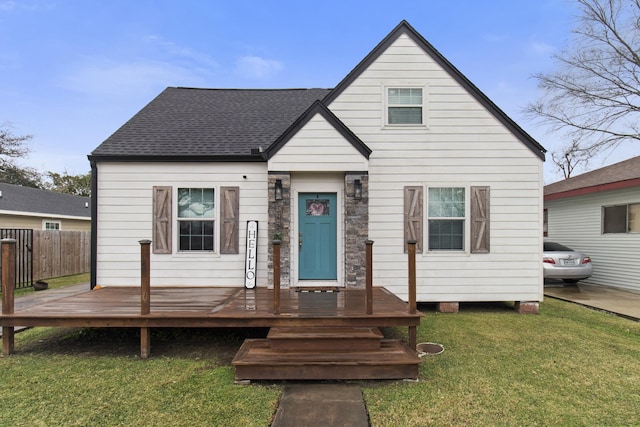 view of front facade with a front lawn and a deck