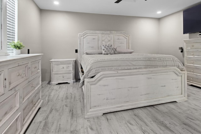 bedroom with ceiling fan and light wood-type flooring