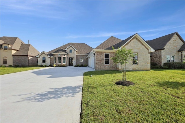 9250 Bellflower St, Beaumont, TX 77713 - french provincial home with driveway, an attached garage, a front yard, stone siding, and brick siding