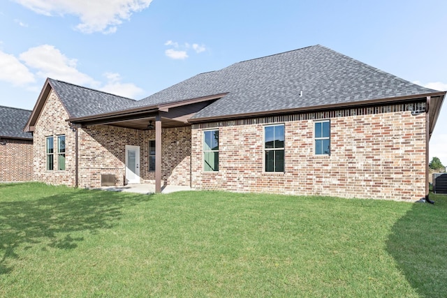 back of property with ceiling fan, a patio area, and a yard