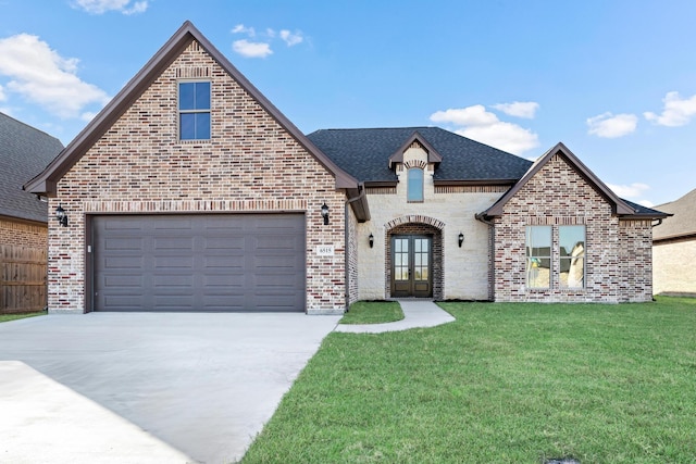 french country style house featuring french doors, a front lawn, and a garage