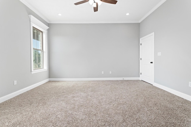 carpeted spare room featuring ceiling fan and ornamental molding