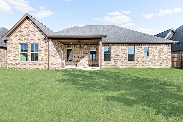 rear view of house with a lawn, ceiling fan, and a patio