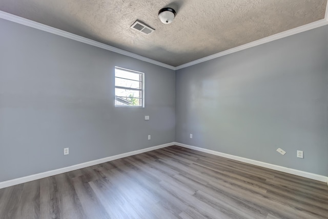 unfurnished room with a textured ceiling, hardwood / wood-style flooring, and ornamental molding