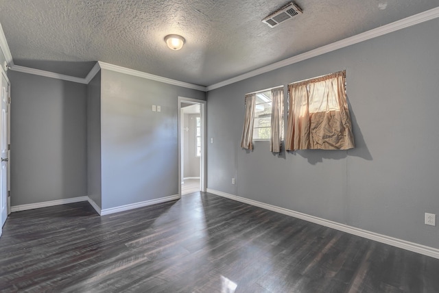 spare room featuring a textured ceiling, crown molding, and dark wood-type flooring