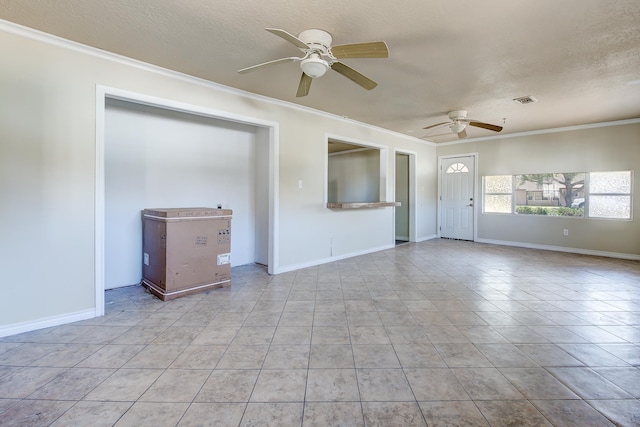 unfurnished living room featuring light tile patterned floors, a textured ceiling, ceiling fan, and ornamental molding