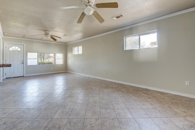 tiled spare room featuring crown molding, a healthy amount of sunlight, and a textured ceiling