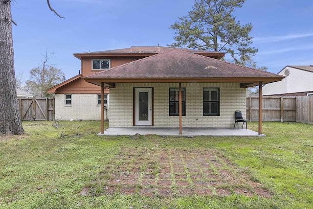 back of property featuring a patio area and a lawn