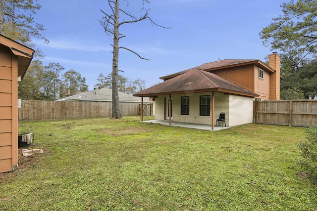 back of house featuring a yard and a patio area