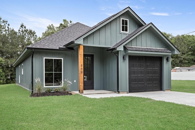 460 Myrtle, Silsbee, TX 77656 - view of front of house with a shingled roof, an attached garage, board and batten siding, a front yard, and driveway