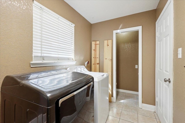 6006 Hazelwood Dr, Orange, TX 77632 - washroom with washer and dryer and light tile patterned floors