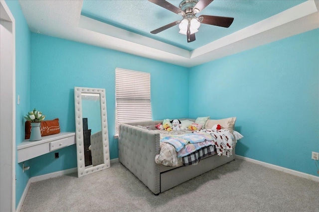 6006 Hazelwood Dr, Orange, TX 77632 - bedroom with a raised ceiling, light carpet, a textured ceiling, and ceiling fan
