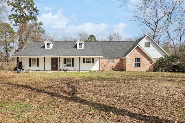 view of front of home with covered porch and a front lawn