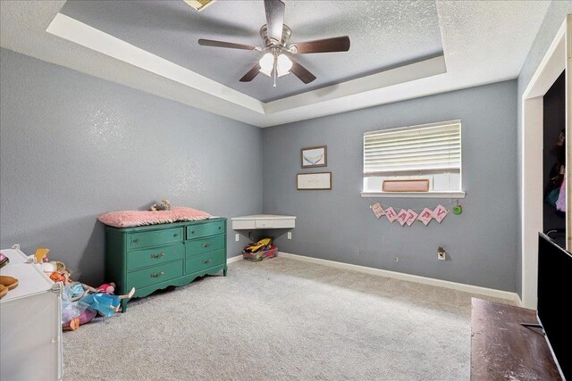 6006 Hazelwood Dr, Orange, TX 77632 - rec room featuring ceiling fan, a raised ceiling, carpet, and a textured ceiling