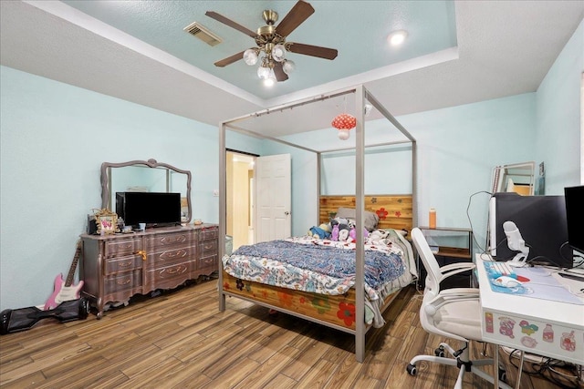 6006 Hazelwood Dr, Orange, TX 77632 - bedroom featuring hardwood / wood-style floors, a tray ceiling, and ceiling fan