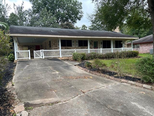 ranch-style home featuring a carport