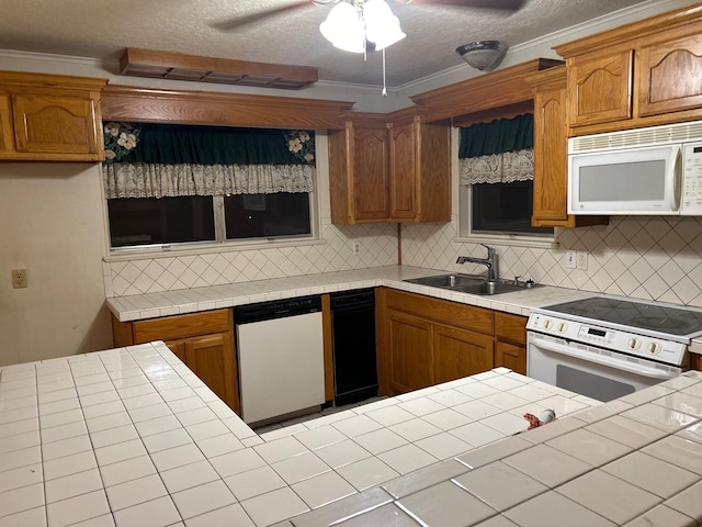 kitchen with sink, tasteful backsplash, tile countertops, a textured ceiling, and white appliances