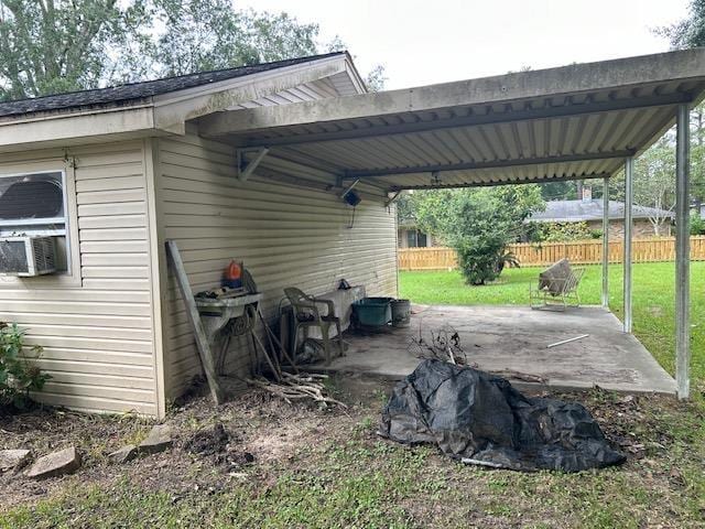 view of vehicle parking with a yard and a carport