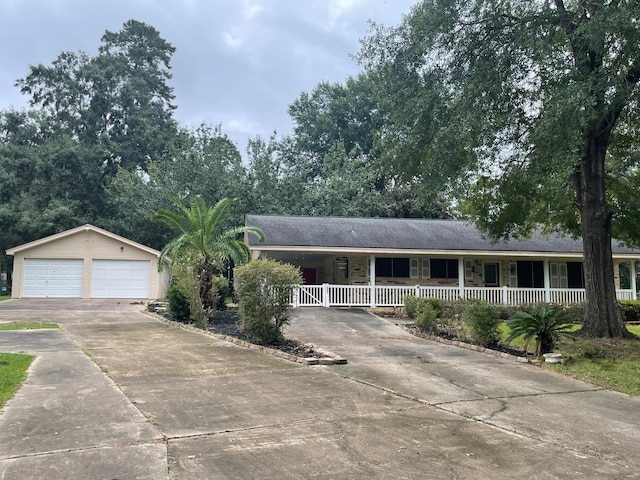 single story home with a porch, a garage, and an outdoor structure