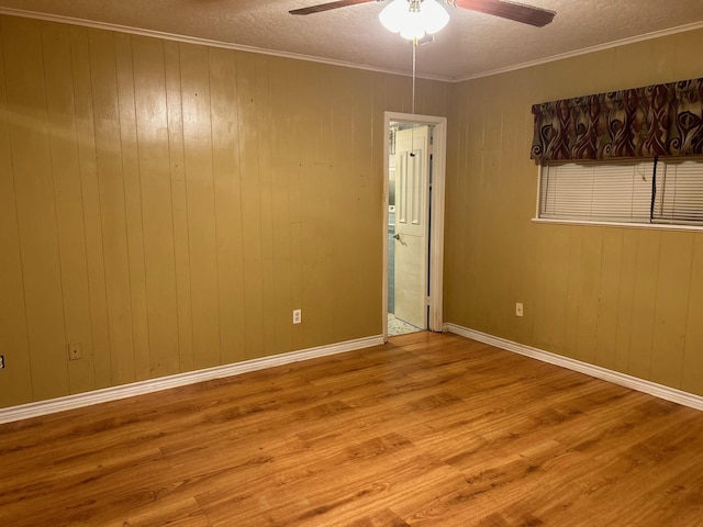 unfurnished room featuring ceiling fan, light hardwood / wood-style floors, and a textured ceiling