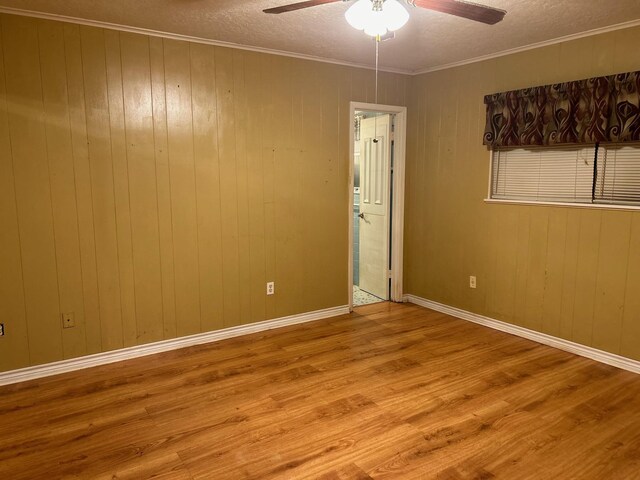 unfurnished room featuring ceiling fan, light hardwood / wood-style floors, and a textured ceiling