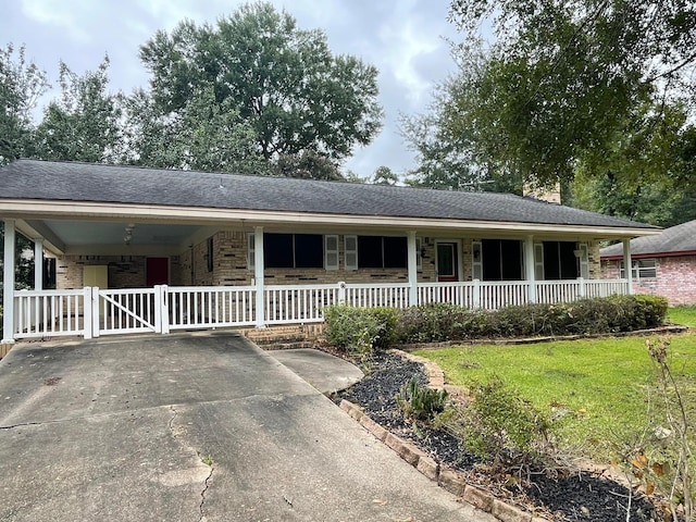 ranch-style house featuring a carport and a front yard