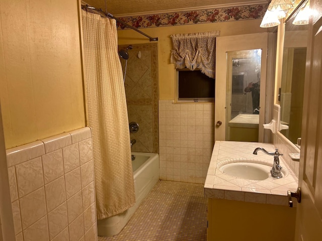 bathroom with shower / bath combo with shower curtain, vanity, tile walls, and tile patterned flooring