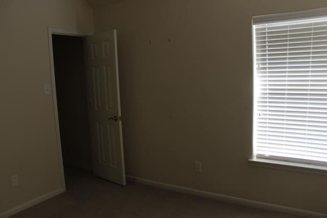 spare room with baseboards