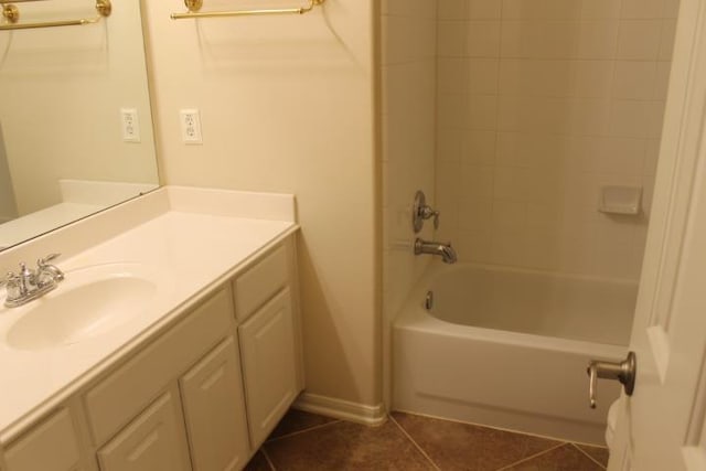 bathroom featuring tile patterned floors, bathtub / shower combination, vanity, and baseboards