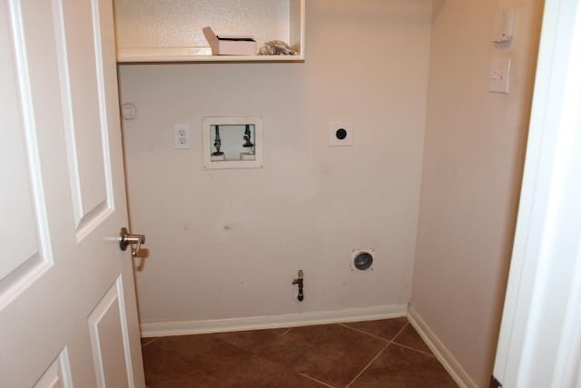 washroom with baseboards, gas dryer hookup, electric dryer hookup, washer hookup, and dark tile patterned floors