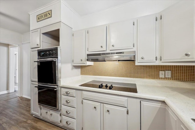 2342 Briarcliff Dr, Beaumont, TX 77706 - kitchen featuring under cabinet range hood, black appliances, light countertops, white cabinets, and crown molding