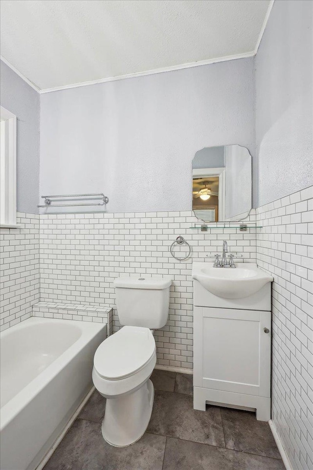 2342 Briarcliff Dr, Beaumont, TX 77706 - bathroom with crown molding, tile walls, toilet, vanity, and a tub