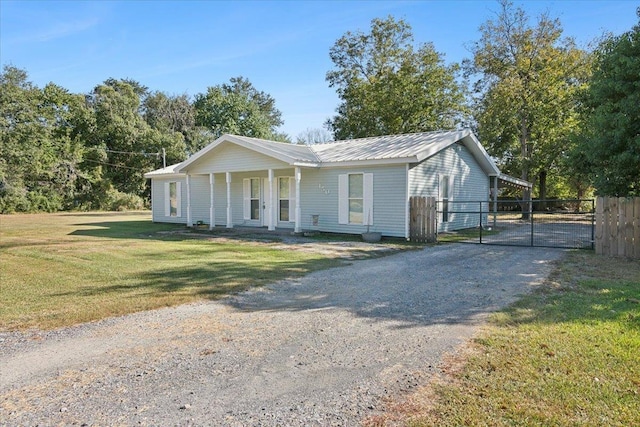 ranch-style home featuring a porch and a front yard